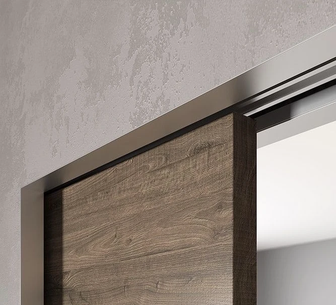 Close up of a wood sliding pocket door with concealed metal track system