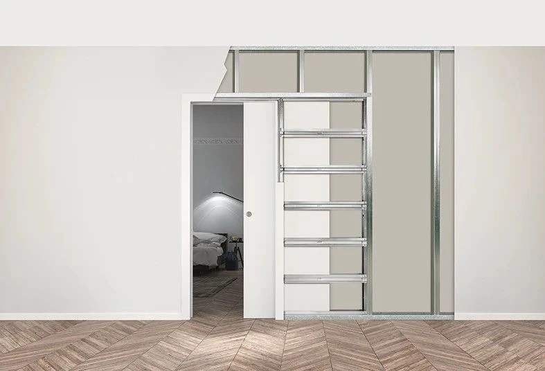 Pocket door installation showing metal wall frame and concealed sliding door system