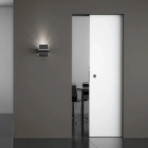 Modern white single pocket door partially open in a minimalist interior