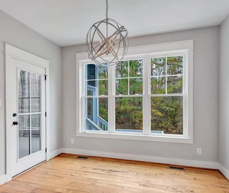 White double hung windows with divided light sashes installed in a modern residential room