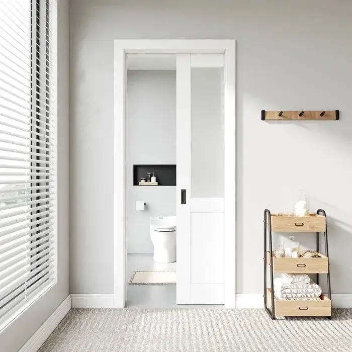 White single pocket door for a bathroom entrance with recessed handle